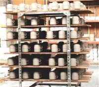 Mugs drying after glaze has been applied.